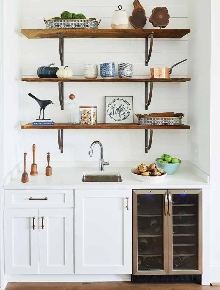Reclaimed wood shelves set atop custom wrought-iron brackets with a natural patina