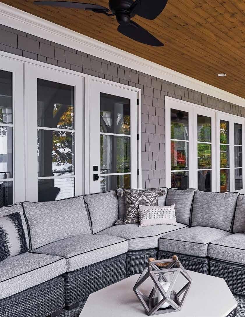 The back porch is a choice gathering place, with plenty of seating from Summer Classics, including swivel chairs