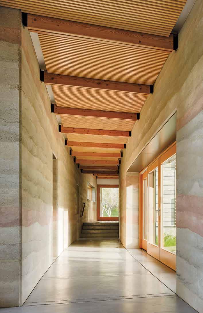 Left: Thick rammed-earth walls, built by Stocker and