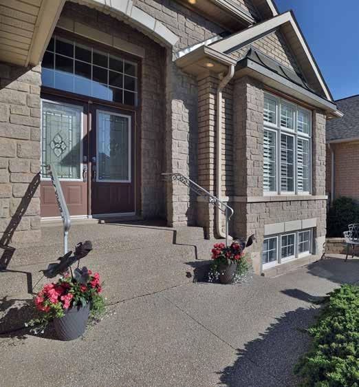 Extensive professional landscaping with exposed aggregate driveway, walkways, steps, front patio and terraced steps/ staircase to the rear yard and upgraded gates with decorative iron inserts on both