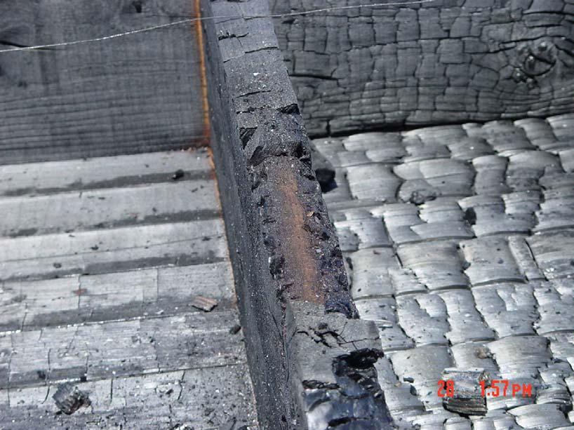 Close-up of exposed joist with char