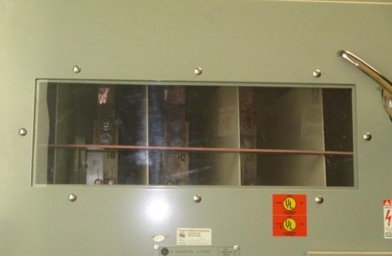 The existing switches had a large Plexiglass viewport (See Figure 1) in the upper portion of the cabinet and arc flash barriers between the fuses at the bottom of the cabinet.