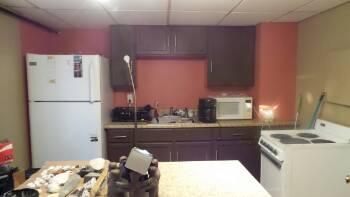 1. Kitchen Interior Unit 4 Range top functioning properly at time of inspection.