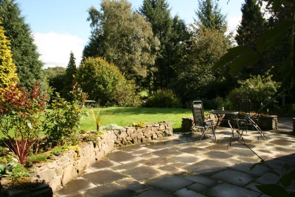 A large paved patio area with access from the lounge. The rear garden is terraced with drying area and patio area.