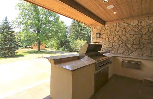 dinner parties, and glass patio doors leading to the outdoor kitchen and stamped concrete patio.