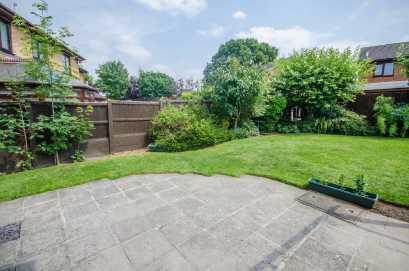 mainly to lawn with an extensive flagged patio area with wooden pergola and deep well