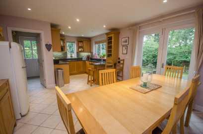 . KITCHEN AREA Fitted with a modern range of oak fronted base and wall level units incorporating drawers, cupboards and a glazed display cabinet with granite
