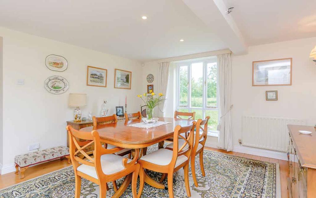 The dining room has a large window with views of the open countryside and we can