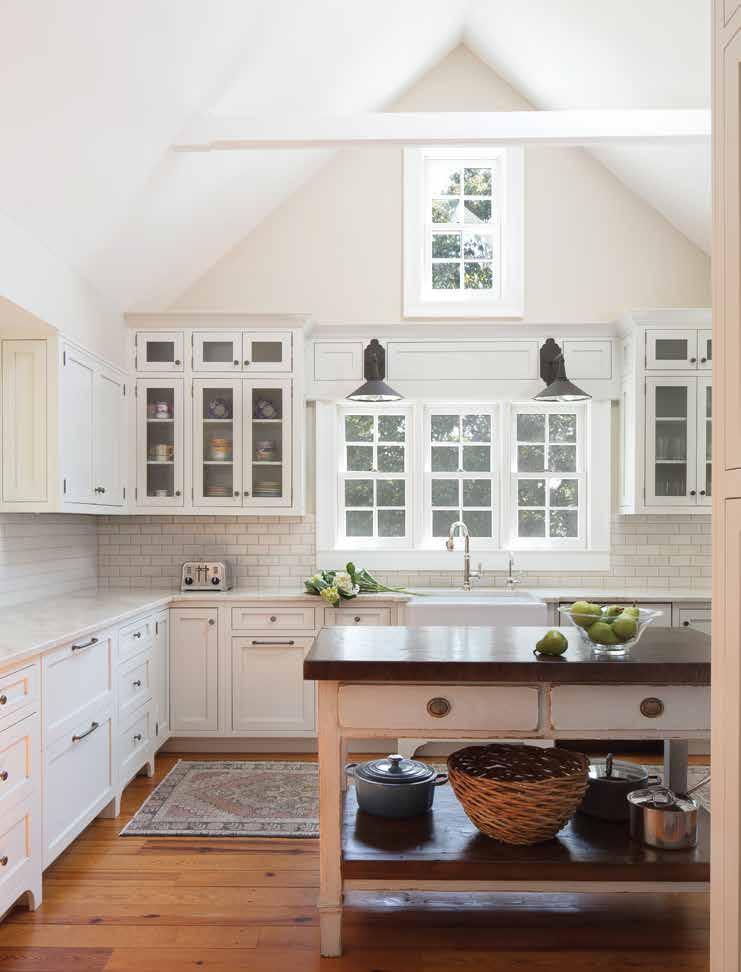 The kitchen island is an old, reclaimed French piece Jane Goss purchased from 1st Dibs. White quartzite countertops are complemented by Currey & Company fixtures.