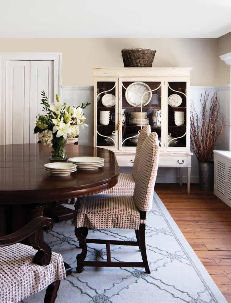 Below: The oval mahogany dining table, chairs covered in a printed cotton fabric, and textured area rug work in unison with the vintage chest that displays Goss china and serveware.