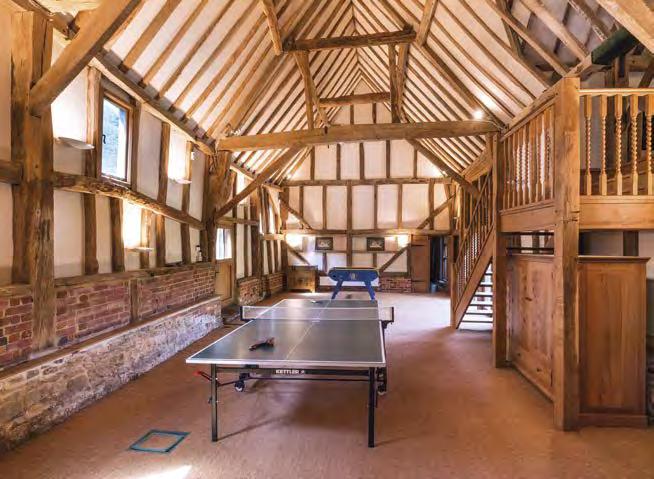 The barn comprises two linked rooms with the main room having french doors opening onto a small patio, plus two further rooms arranged as a gymnasium and a kitchenette.