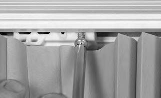 If you used spacer blocks or extension brackets with the installation brackets, use an extension bracket to mount the stationary rail away from the wall.