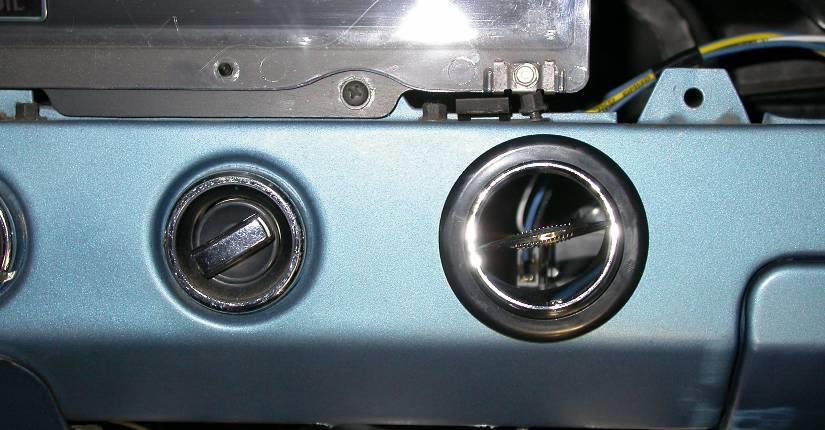 Locate and Drill (1) 2 ¼ dia. hole on drivers lower part of instrument panel to right of cigarette lighter. Center of the hole will be located vertically on center line of raised portion of the panel.