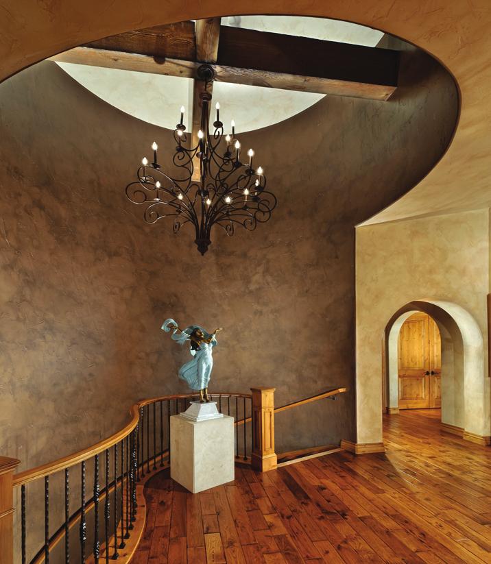The mixed material, such as wrought iron, stone, stucco and heavy beams, encompass the overall design aesthetic for this Tuscan-themed home.