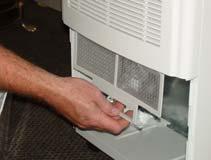 Remove the cap from the rear of the dehumidifier and insert into the collection tray inside the front of the unit