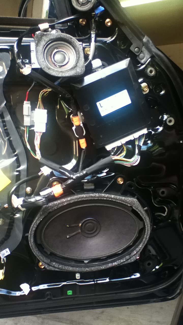 There are four screws, a clipped in wire, and an electrical connector that need to be removed for the woofer.