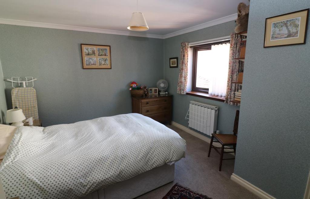 Bedroom Two measuring approximately 13 4 x 10 6 (4.06 x 3.2m) with front elevation double glazed window, panelled radiator, coved ceiling, light and power points.