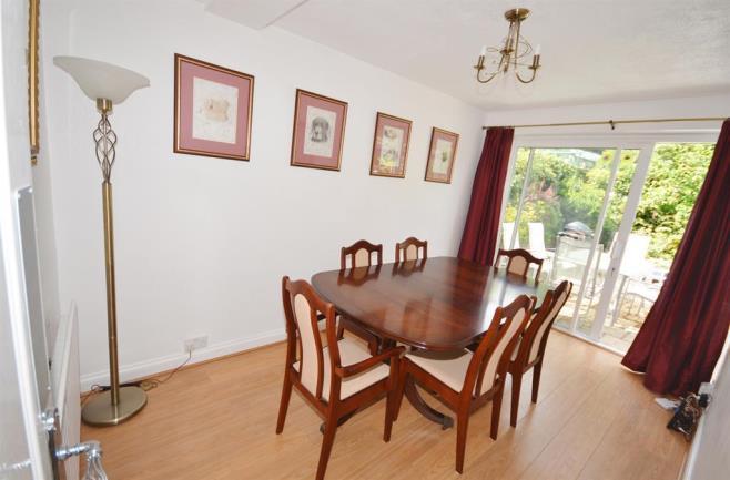 DINING ROOM 4.27m (14' 0") x 2.31m (7' 7") With panelled radiator, wood laminate flooring and double glazed sliding patio doors leading to rear gardens.