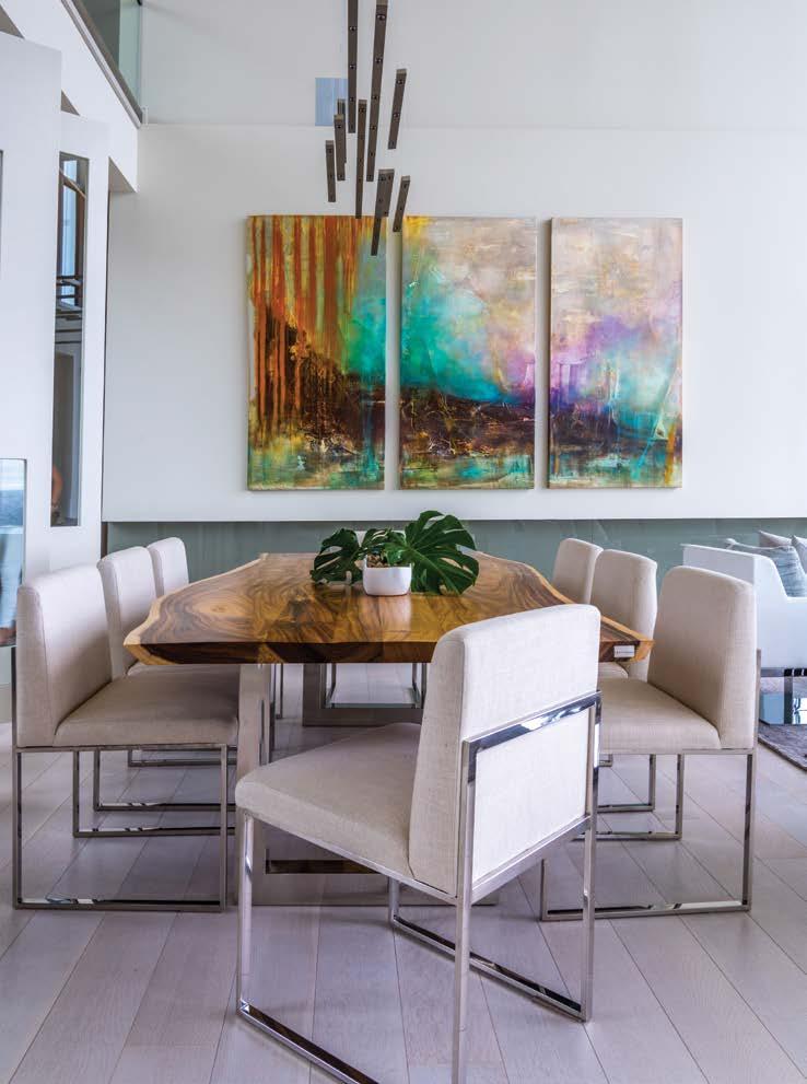 integrated artwork in the front foyer. A live-edge dining table brings another natural element into the open-plan main floor.