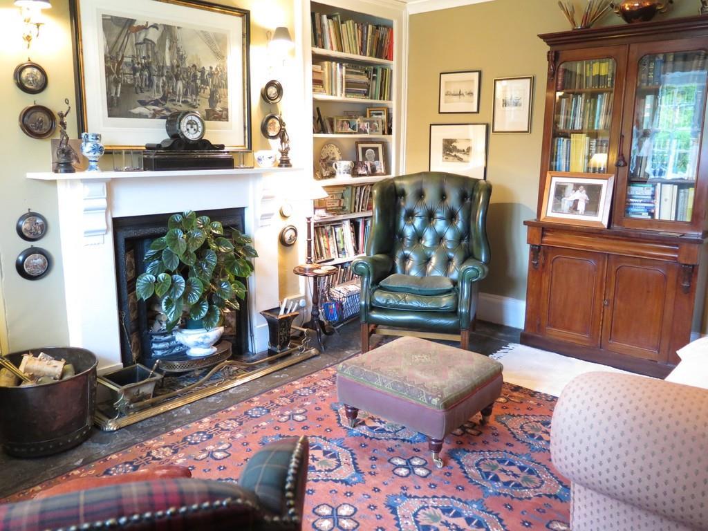 Inside On entering the property from the formal front door is a sitting room and drawing room, one having an open fire, the other having a gas fire and both with shutters and windows overlooking the