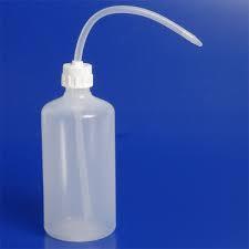 Wash Bottle A wash bottle has a spout that delivers a wash solution to a