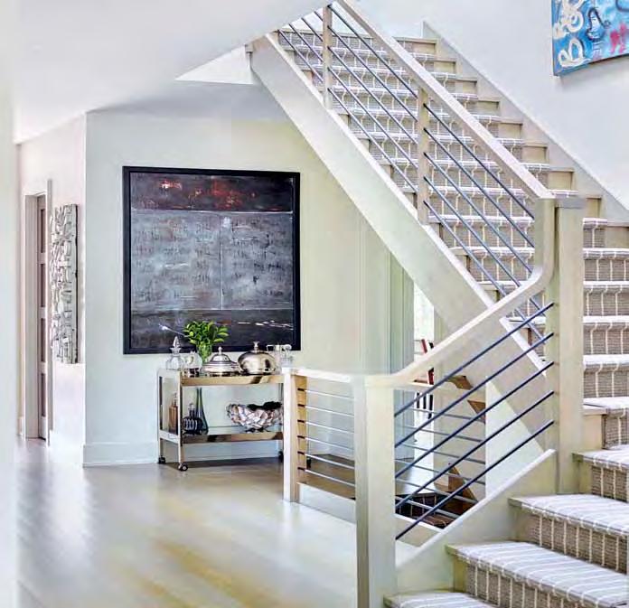 Opposite, bottom: A wool runner from Carpet Central & Hardwood Flooring and a railing fabricated by Signature Stairs leads one up the stairway to the home s private spaces.
