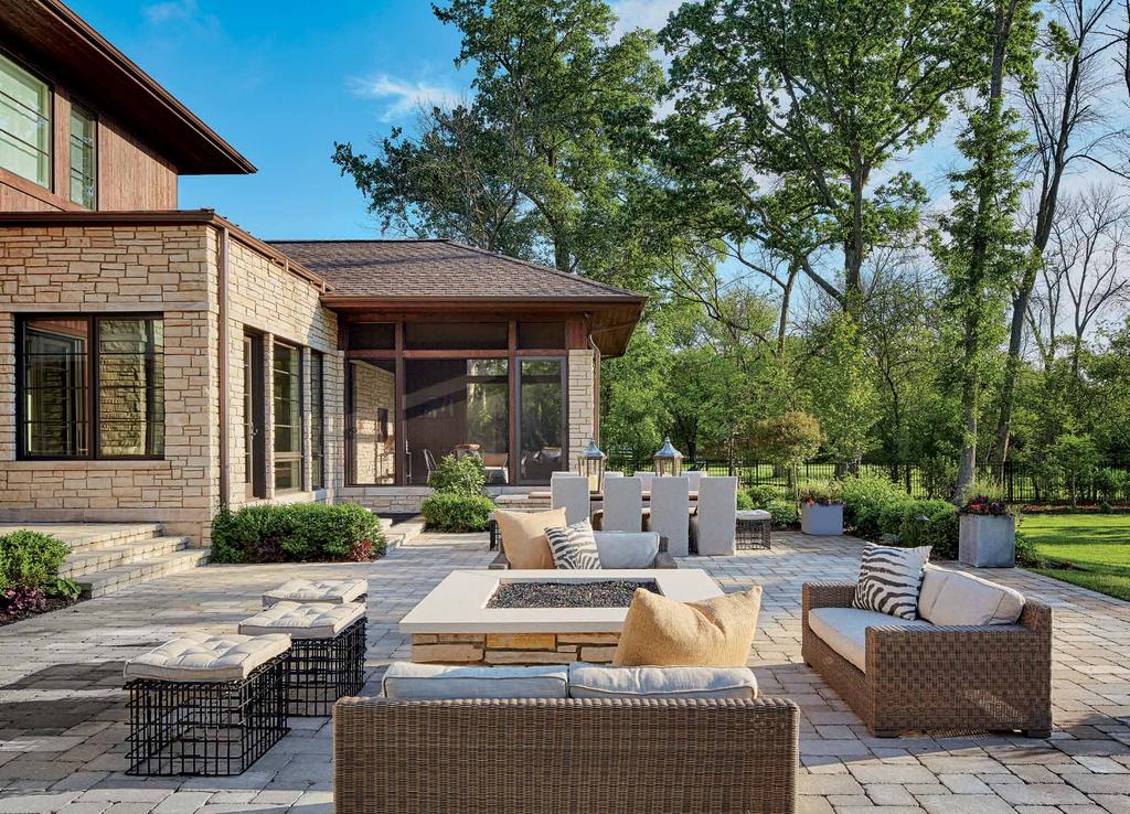 Outdoor living spaces are both comfy and welcoming for family and friends and include Restoration Hardware furnishings that surround a fire pit, which coordinates with the exterior stone from