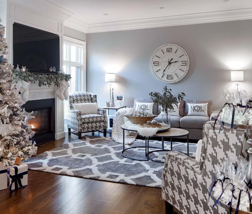 It s cosy and warm with the addition of chunky blankets and faux fur accents. BELOW: The entryway is made pretty with wrapped gifts and the glow of a pretty white tree.
