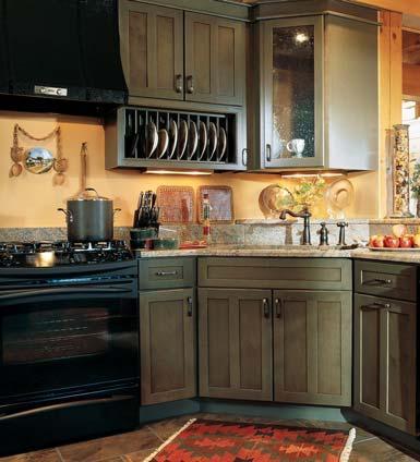In the kitchen, the refined country look is anchored by dark green KitchenMaid cabinets, which provide a perfect contrast with warm, golden walls.