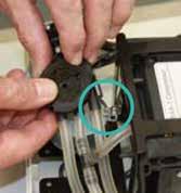 10 Using the socket wrench, unscrew the two bolts that hold the motor in place, noting the position of both the bolts and the L shaped metal bracket (closest to the
