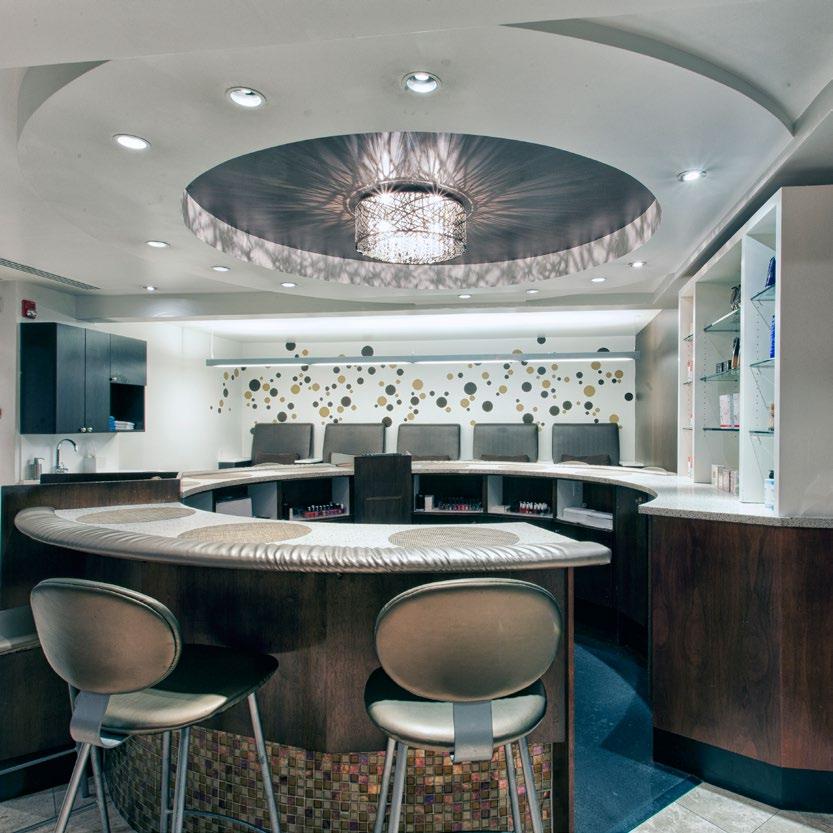 bubbly Adam Broderick Salon & Spa Renovation A circular nail bar and reflective ceiling add a touch of whimsy in the