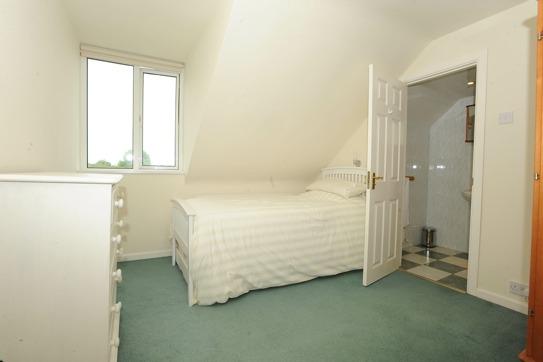 bed; fully fitted wardrobes; cupboards; desk area with shelving over and range of drawers. BEDROOM 5 3.38m (11'1) x 2.