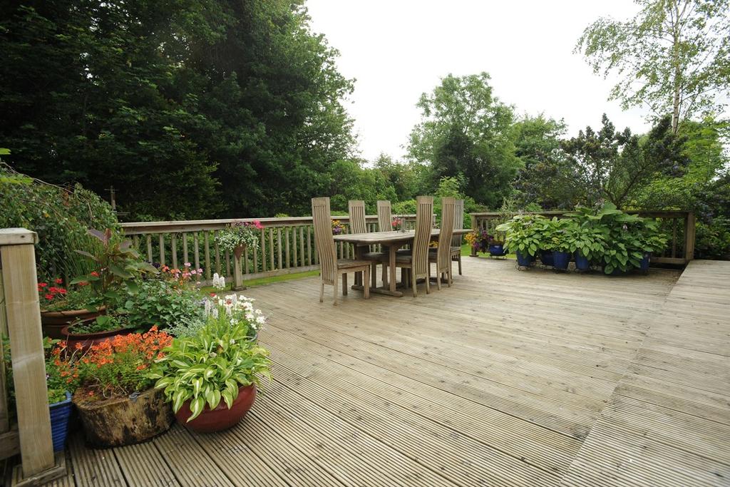 GARDENS Extensive raised wooden decking leading from the sun room provides an ideal outdoor entertainment area.