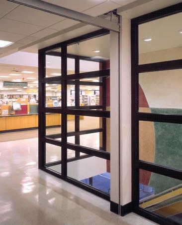 Image left L Anse Creuse High School, Harrison, MI: Partition with a double leaf door glazed with Pilkington Pyrostop.