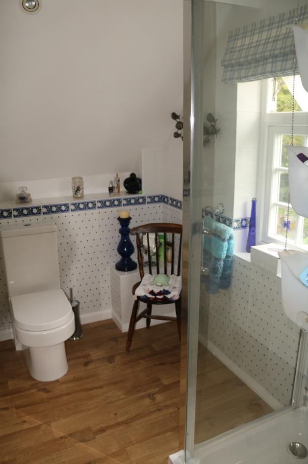 Master Bedroom En Suite Shower Room comprising of modern suite with vanity unit, hand wash basin with drawers
