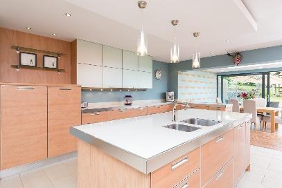 05m (6'9) Single drainer stainless steel sink unit with mixer taps; range of oak laminate eye and floor level cupboards and drawers; formica worktops; space and plumbing
