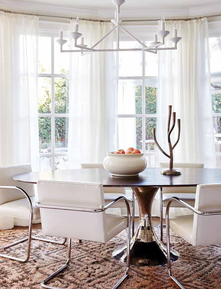 The casual dining area features vintage chrome cantilever BRNO style chairs reupholstered in vinyl from Modern Fabrics in