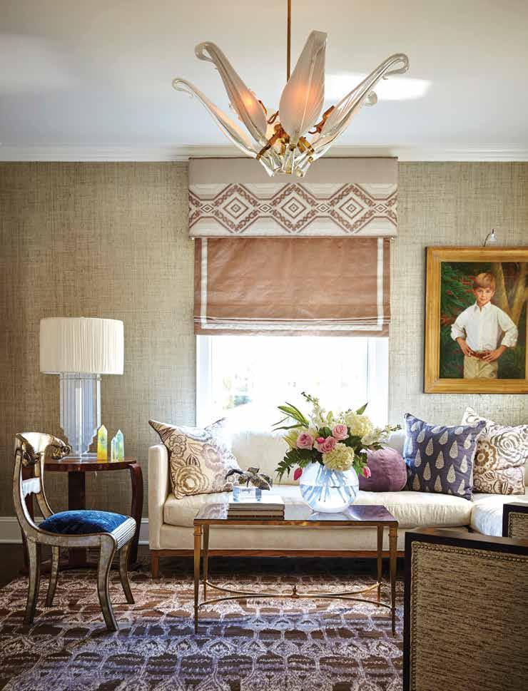 Texture, luxury, and light fill this beautifully curated sophisticated sitting room. The wallpaper is Max s Metallic Raffia in natural silver by Phillip Jeffries.