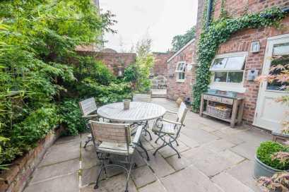 further flagged patio garden enclosed by brick walling with an additional brick-built store Outside light The side and rear gardens enjoy a sunny aspect and a good degree of privacy