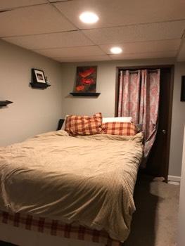 1. Bedroom Room Basement Bedroom 1 Walls and ceilings appear in good condition overall. Flooring is carpet.