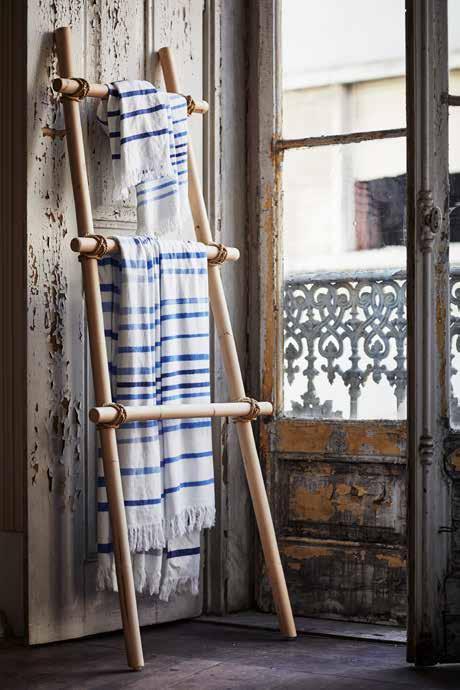 The rattan clothes stand is elegant on its own, but most beautiful