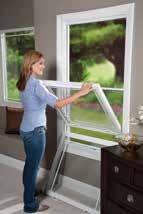 Push both buttons toward the center of the sash to release them from the window frame.