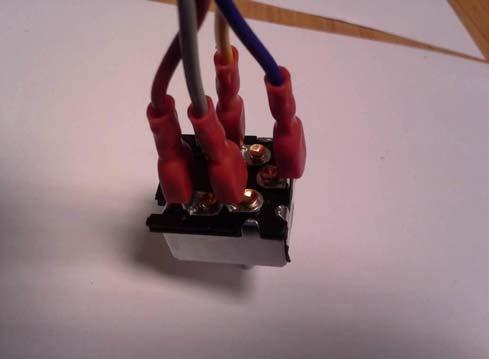 p. 5 of 8 1.11 Connect the heater wiring to the heater switch as shown in Fig. 1.11 (red is on the left, yellow is up top, blue is to the right, and the last wire is to the bottom).