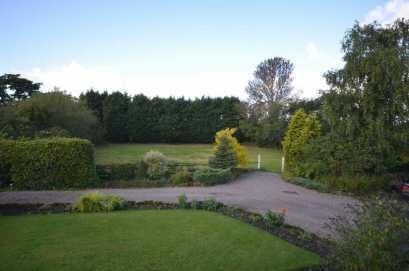 evergreen borders together with a kitchen garden and provide a suitable setting for the property.