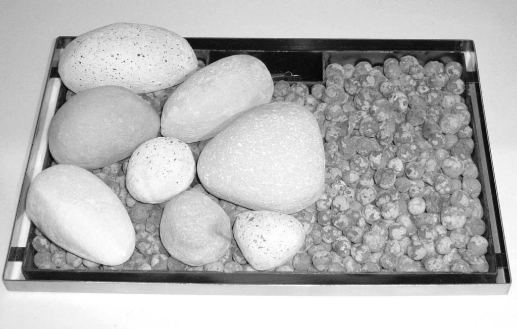 The letters are on the bottom of the pebbles and should face downwards. H. Next, place the pebbles marked I, J and K as shown.