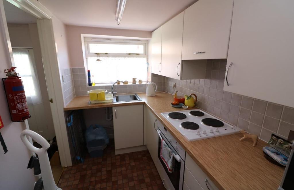 Kitchen measuring approximately 5 4 x 9 8 (1.64 x 2.99m), with fitted kitchen with work top surface, drawers and storage cupboards under. NEFF 4 ring hob top with oven under. Space for fridge.