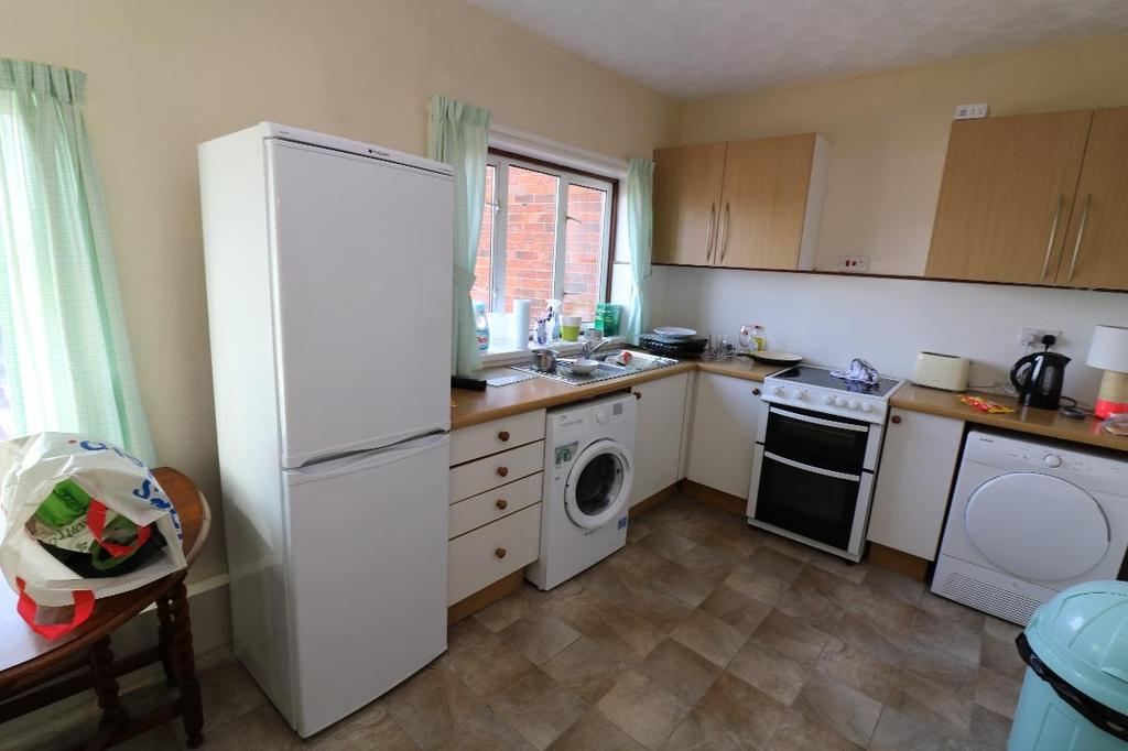 Kitchen measuring overall approximately 13 x 8 7 (3.96 x 2.65m) fitted kitchen comprising of worktop surfaces, drawers and storage cupboards.