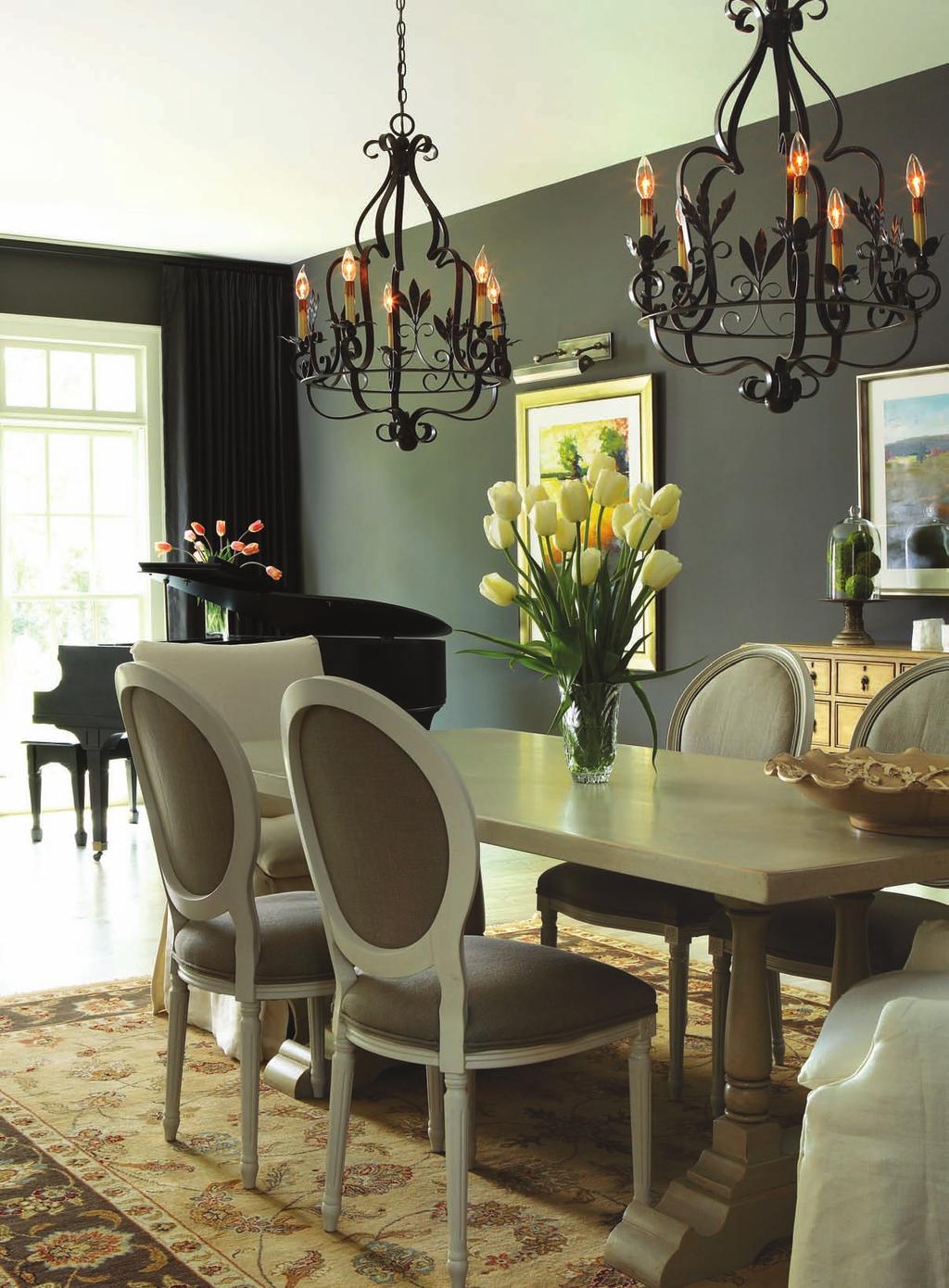 Dine in Style. The dining room table sits near an area devoted to music. A pair of iron chandeliers add drama and charm, making the room even more special, says Janie.