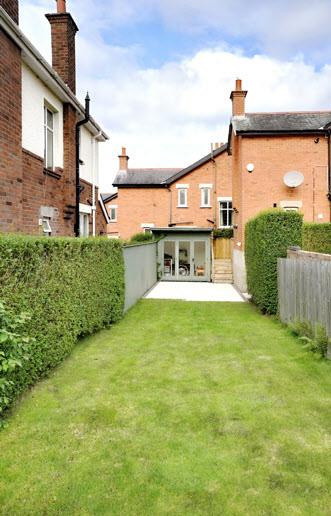 Enclosed private rear gardens in lawns, landscaped patio and feature raised decking with electric awning.
