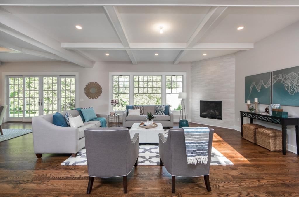 With extensive custom millwork, luxurious finishes, high ceilings and warm hued hard wood floors throughout, this home simply exudes grace and style.